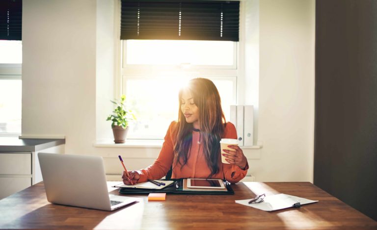 Entrepreneur working at her desk after doing positive affirmations.