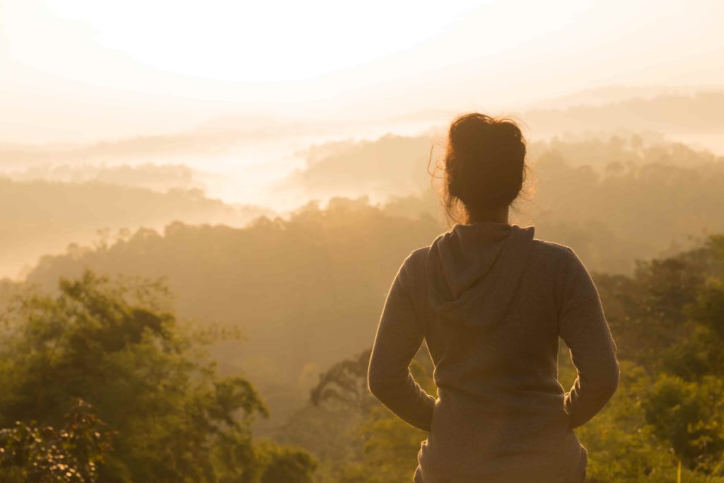 Woman letting go of what is bothering her and enjoying nature